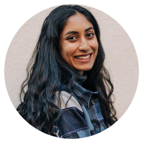 Headshot of a smiling woman with long lightly curl.jpeg