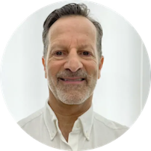 Headshot of man with short hair and white scruff_