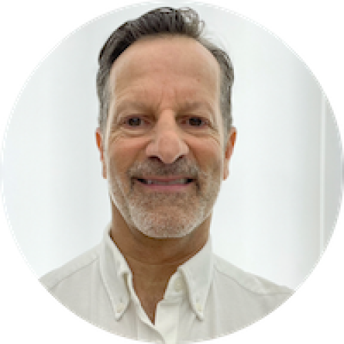 Headshot of man with short hair and white scruff_