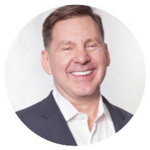 headshot of a smiling man with short brown hair we